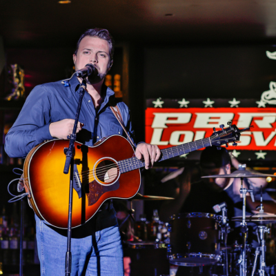 Walker Montgomery playing live music at PBR Cowboy Bar